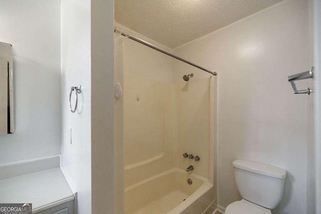 bathroom featuring  shower combination, toilet, and a textured ceiling