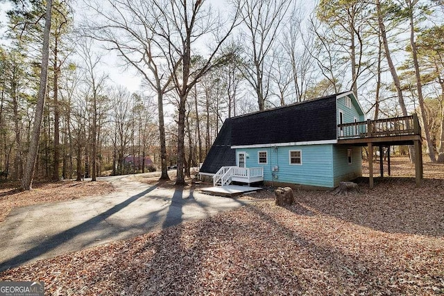 back of house featuring a deck