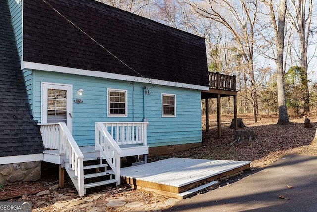 rear view of property featuring a deck