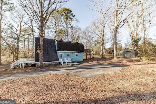 exterior space with a shed and a deck