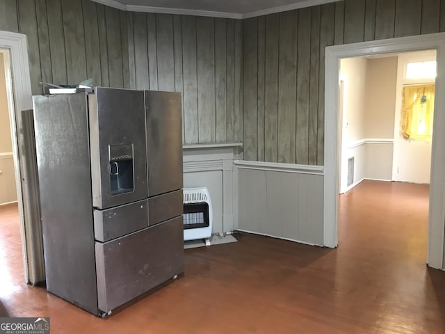 kitchen featuring visible vents, stainless steel fridge with ice dispenser, wood finished floors, heating unit, and crown molding