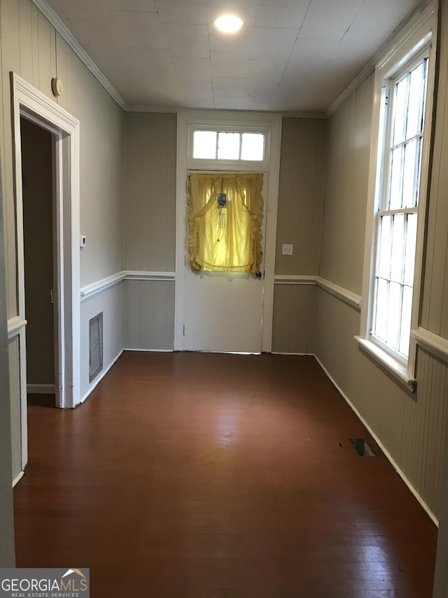 interior space with plenty of natural light, visible vents, and wood finished floors