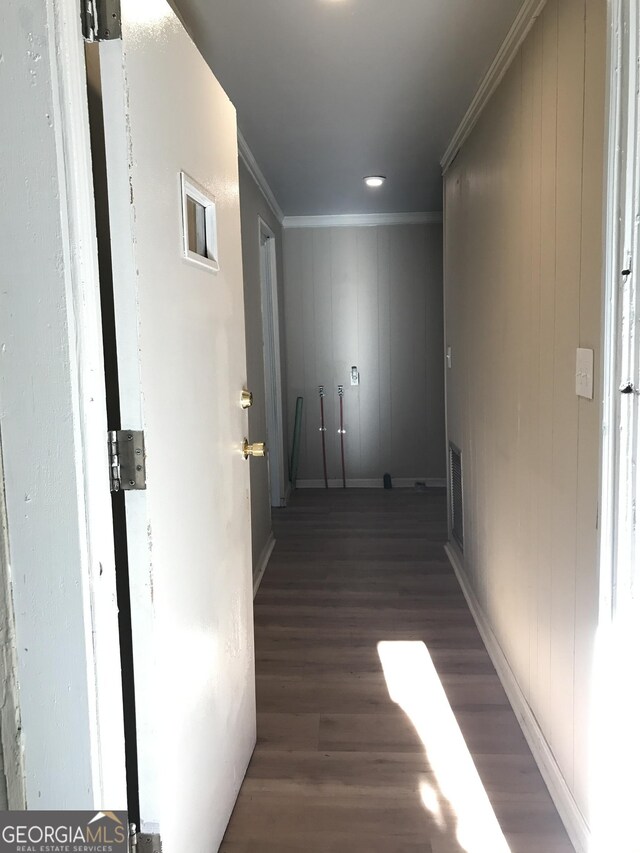 hall featuring crown molding and dark wood-type flooring