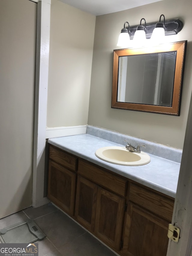 bathroom featuring tile patterned flooring and vanity