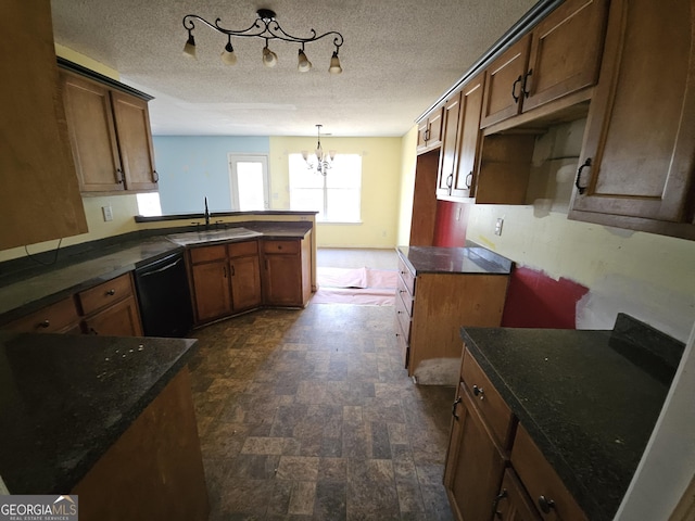 kitchen featuring sink, hanging light fixtures, black dishwasher, a textured ceiling, and kitchen peninsula