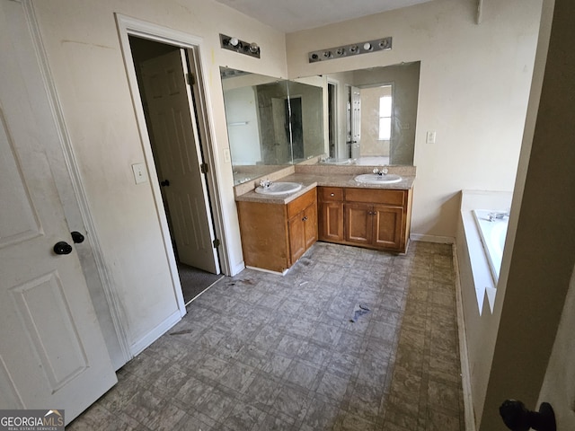 bathroom with vanity and a tub