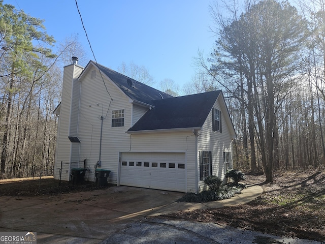 view of side of home with a garage