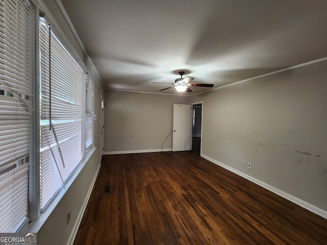 spare room with ornamental molding, dark wood-type flooring, and ceiling fan