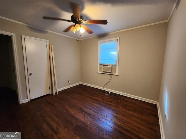 spare room with ceiling fan, ornamental molding, and dark hardwood / wood-style flooring