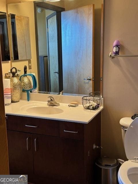 bathroom with vanity and toilet