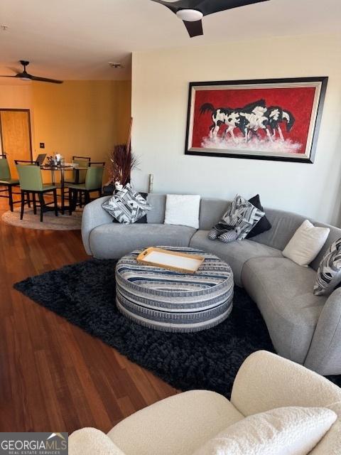 living room with hardwood / wood-style flooring and ceiling fan