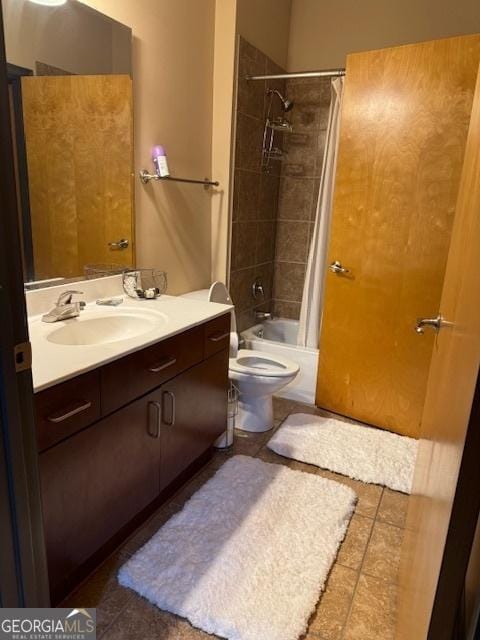 full bathroom with vanity, shower / tub combo with curtain, and toilet