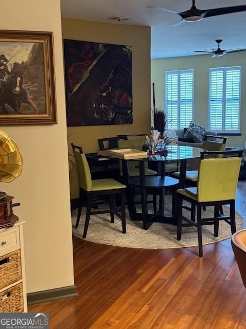 dining space featuring ceiling fan and wood-type flooring