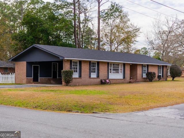 single story home featuring a front yard