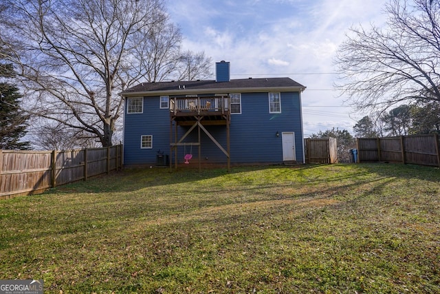 rear view of property featuring a wooden deck, a yard, and central air condition unit