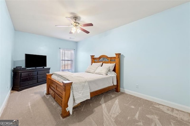 bedroom featuring light colored carpet and ceiling fan