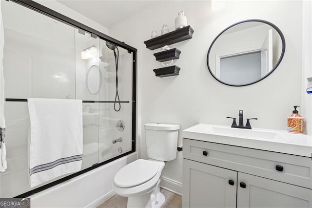 full bathroom with enclosed tub / shower combo, vanity, tile patterned floors, and toilet