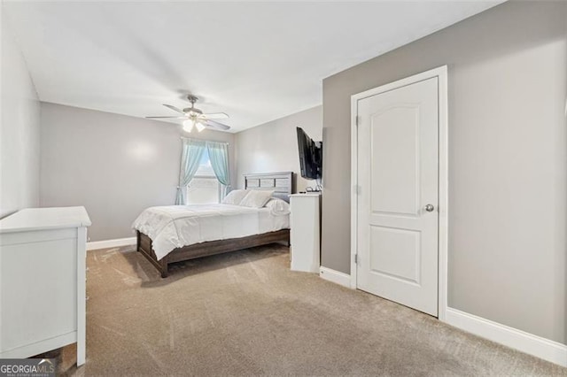 bedroom featuring light colored carpet and ceiling fan