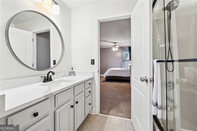 bathroom with tile patterned flooring, vanity, a shower with door, and ceiling fan