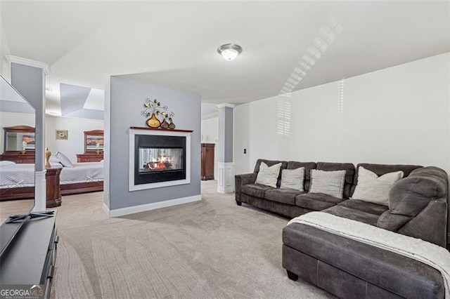 carpeted living room featuring a multi sided fireplace