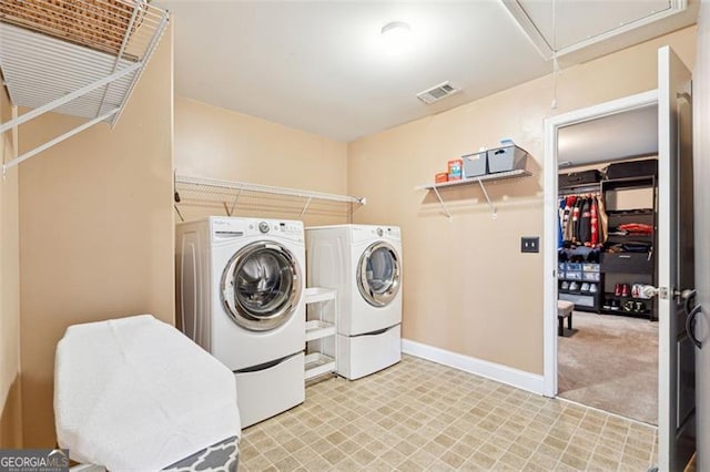 laundry area with independent washer and dryer