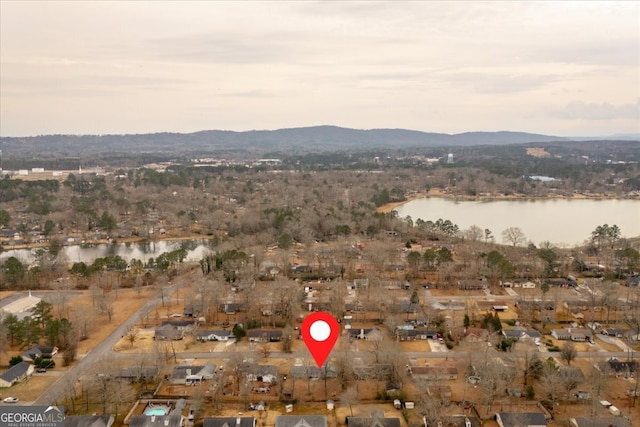 drone / aerial view with a water and mountain view