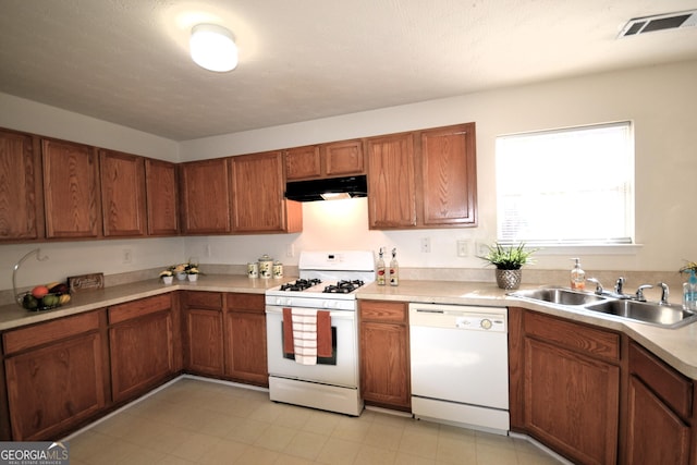 kitchen featuring sink and white appliances