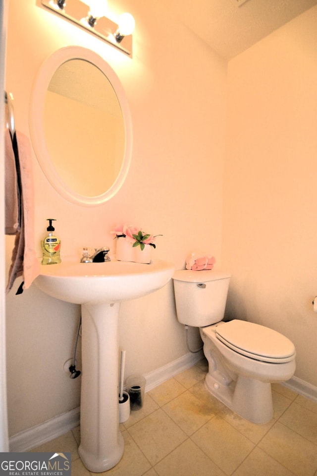 bathroom with tile patterned flooring and toilet