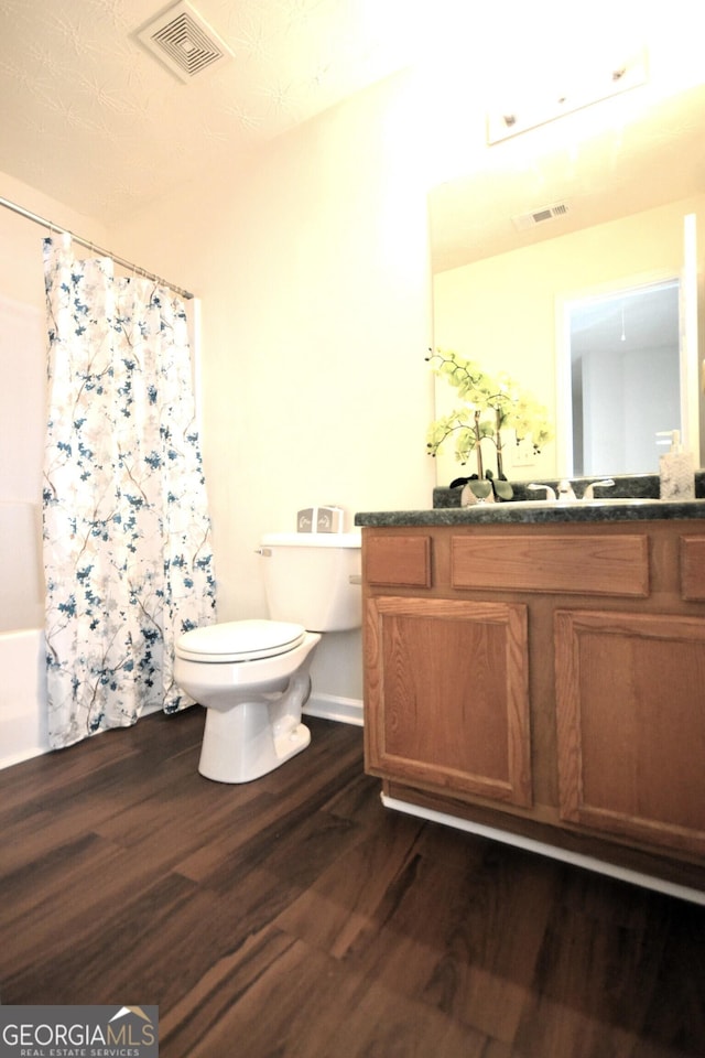 bathroom with vanity, hardwood / wood-style floors, and toilet