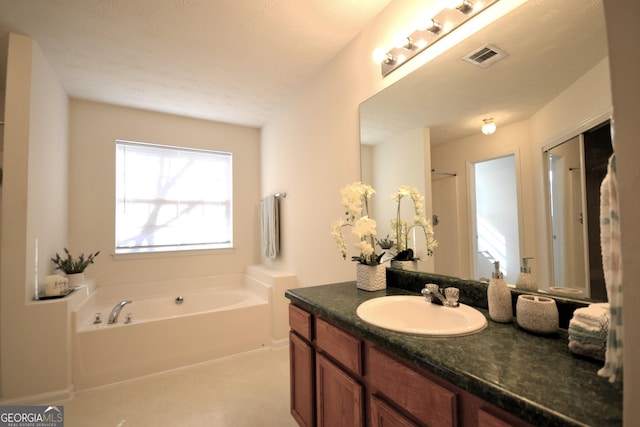 bathroom featuring a bathing tub and vanity