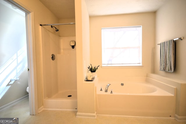 bathroom featuring independent shower and bath and toilet