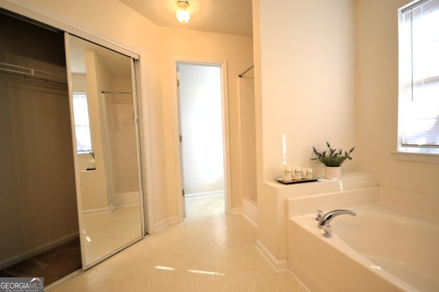 bathroom featuring plus walk in shower and a wealth of natural light