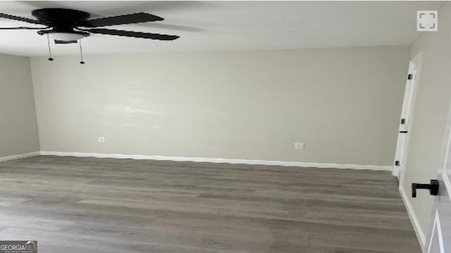 empty room featuring dark hardwood / wood-style floors and ceiling fan