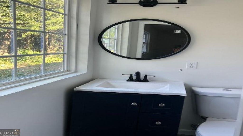 bathroom featuring vanity and toilet