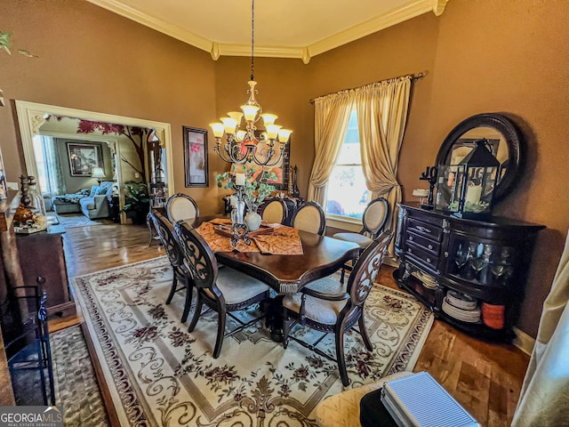 dining space featuring a notable chandelier, ornamental molding, and hardwood / wood-style floors