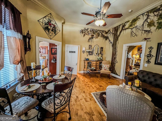 dining area featuring crown molding, ceiling fan, and light hardwood / wood-style flooring