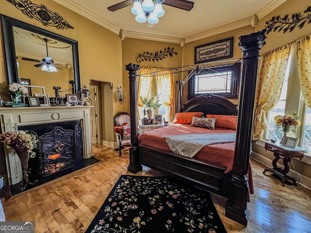 bedroom featuring ornamental molding, hardwood / wood-style floors, and ceiling fan