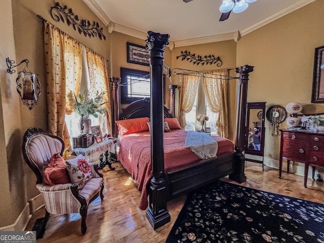 bedroom featuring hardwood / wood-style flooring, ornamental molding, and ceiling fan