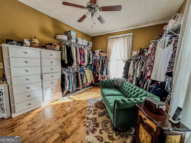 walk in closet with light hardwood / wood-style flooring and ceiling fan