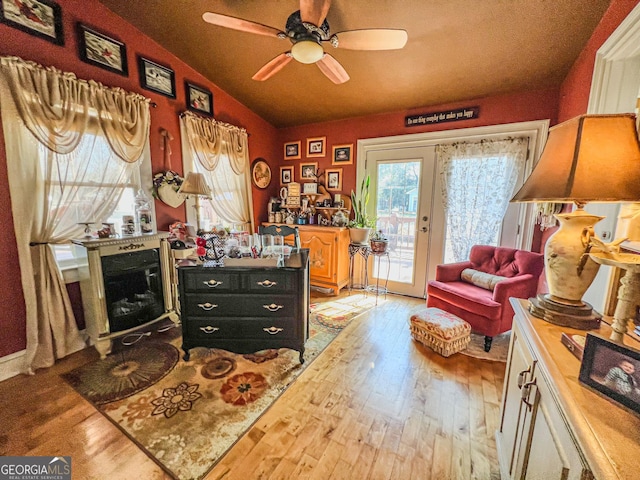 sitting room with french doors, ceiling fan, lofted ceiling, and light hardwood / wood-style flooring