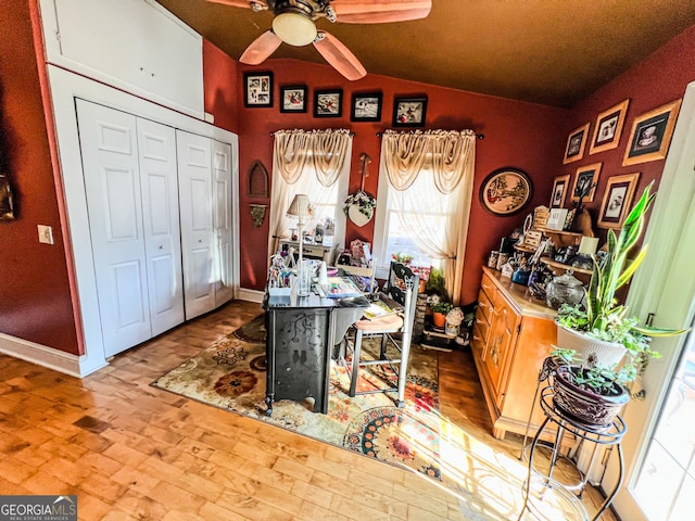 office with ceiling fan, vaulted ceiling, and light hardwood / wood-style flooring