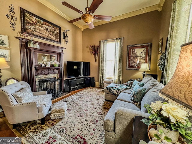 living room with hardwood / wood-style flooring, crown molding, and ceiling fan