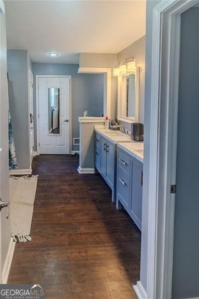 bathroom with vanity and hardwood / wood-style flooring