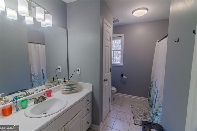 bathroom with vanity, toilet, and tile patterned flooring