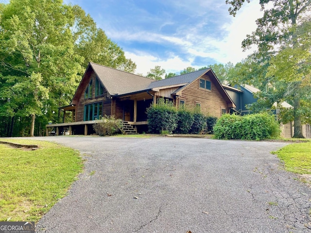 log home featuring a carport