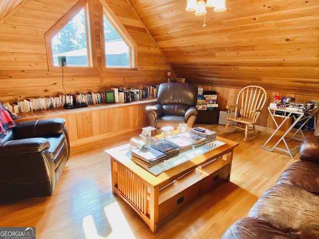 interior space featuring light hardwood / wood-style flooring, wood ceiling, wooden walls, and lofted ceiling