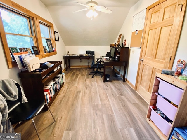 office featuring light hardwood / wood-style flooring, ceiling fan, and vaulted ceiling