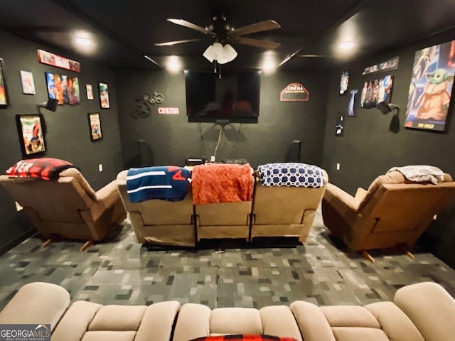 home theater room featuring carpet floors and ceiling fan