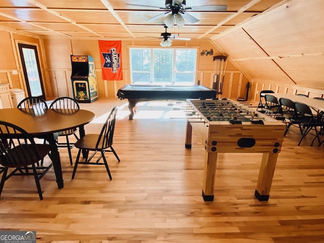 playroom with lofted ceiling, light hardwood / wood-style floors, and washing machine and dryer