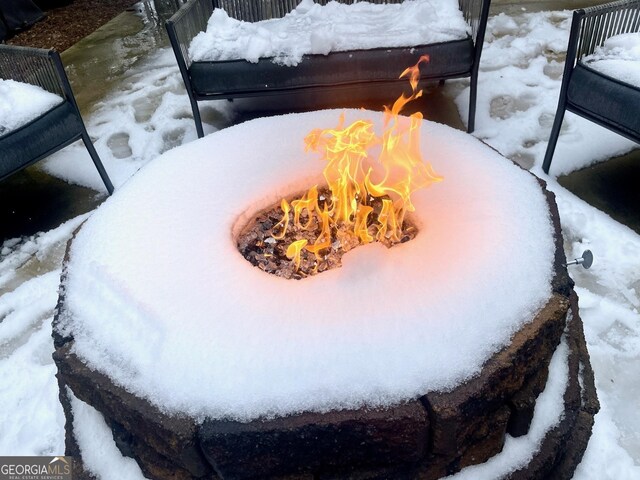 exterior details featuring an outdoor fire pit